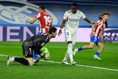 Real Madrid's Belgian goalkeeper Thibaut Courtois stops the ball during the Spanish league football match between Real Madrid CF and Club Atletico de Madrid at the Santiago Bernabeu stadium in Madrid 