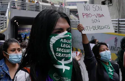 A woman wears a protective face mask with a message that reads in Spanish; "Legal abortion safe and free" during an abortion rights demonstration, outside the offices of the Bolivian Episcopal Confere