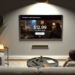 In this photo illustration an Apple TV+ logo is seen on a smartphone screen with an Apple logo in the background.
