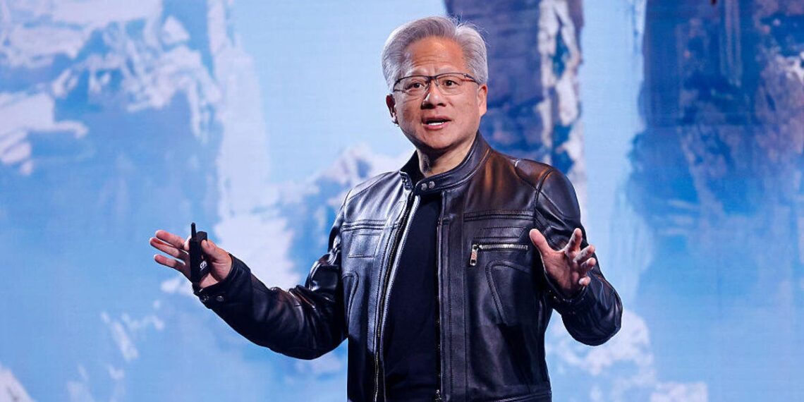 Jensen Huang, wearing a leather jacket, in front of a screen.