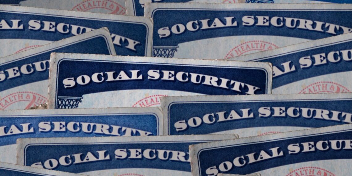 a selection of Social Security cards on a darkened background