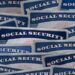 a selection of Social Security cards on a darkened background