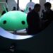 Attendees visit the Google booth where a model of the Android logo is on display at CES 2023 at the Las Vegas Convention Center.