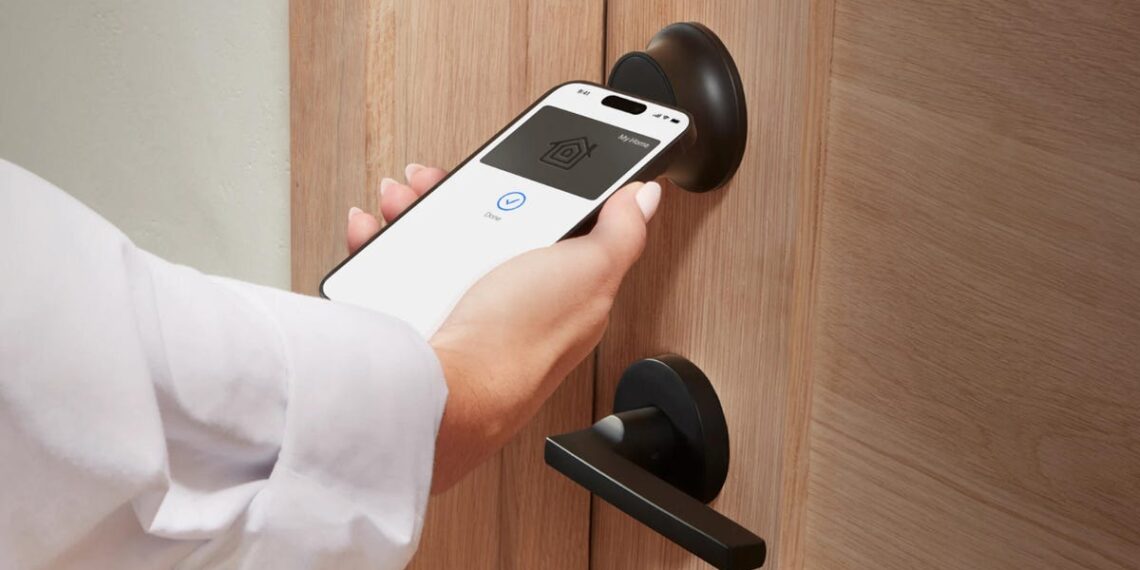 Hands hold a phone key pass up to a Level Lock Pro on a wood door.