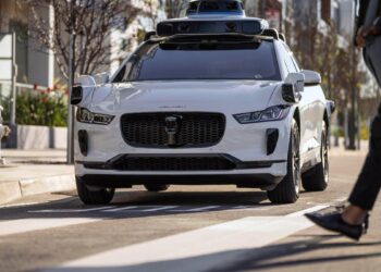 A Waymo Jaguar I-Pace drives on a road
