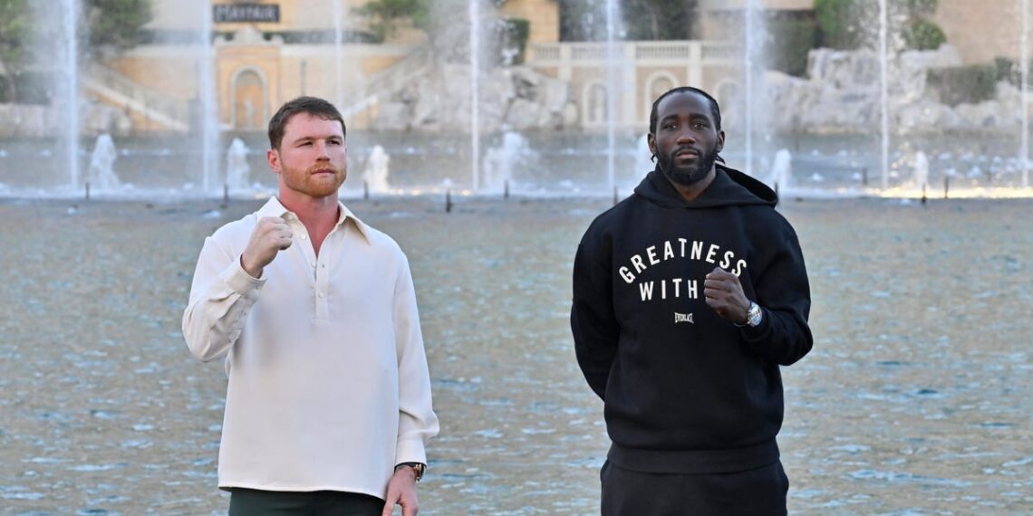 canelo alvarez and terence crawford pose with raised fists