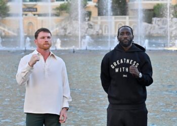 canelo alvarez and terence crawford pose with raised fists