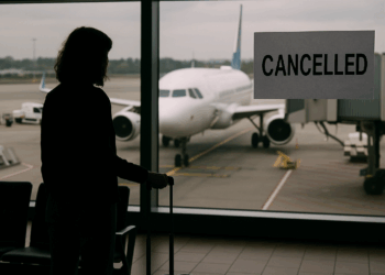 A photo showing a departures board at an airport with delayed and cancelled international flights (gettyimages-1409434718)