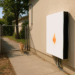Two Tesla Powerwalls sit on the outside of a house.