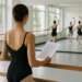Matthew Rushing leads a group of students in the studio. He lunges in 4th position with both arms opening side.