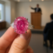 A closeup of a pink diamond ring on a woman's hand.